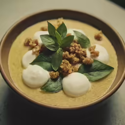 a bowl filled with soup covered in toppings