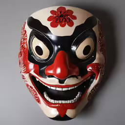 an image of a colorfully painted mask on a wall
