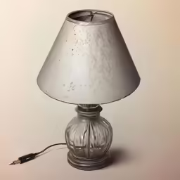 a small lamp with a silver covering on a table