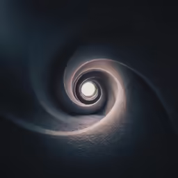 a spiral staircase with a light in it