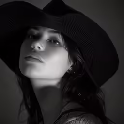 black and white photo of woman wearing hat