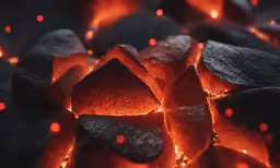 many large pieces of burnt material glowing in bright sunlight