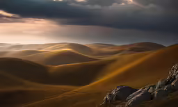 view across rolling hills to sky on cloudy day