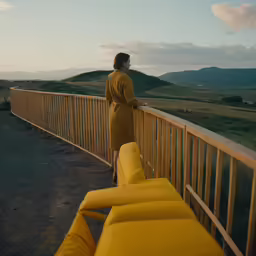 the young woman is looking over the bridge