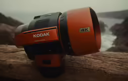 a closeup of an orange kodak camera