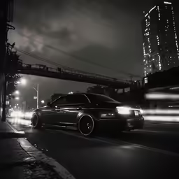 a car driving down a road next to a bridge