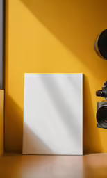 an empty picture frame is shown next to an old digital camera
