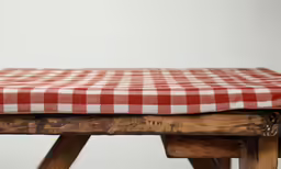 there is a checkered tablecloth placed on top of a wooden chair