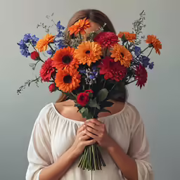woman with flowers in her head holding something
