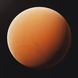 a brown ball of sand sitting in the dark
