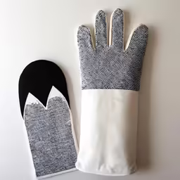 a pair of oven gloves sitting on top of a white counter