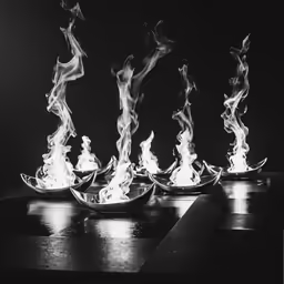 four boats with flames rising from the bottom
