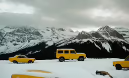 a couple of trucks that are sitting in the snow