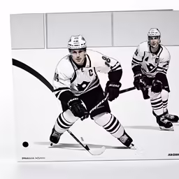 a man holding a hockey stick in front of a sign