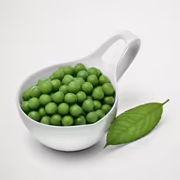 a ceramic scoop filled with green peas and a leaf