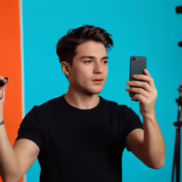 the boy has a phone up in front of his