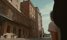 a person stands near some buildings in a city