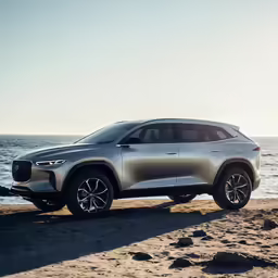 a silver volvo suv sitting on the beach