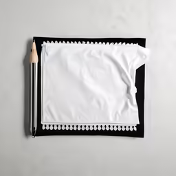 a white napkin with black trim and pencil