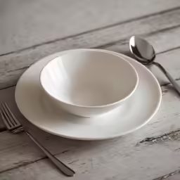 a white plate with silverware next to it