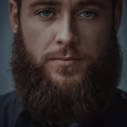 a bearded man wearing a black shirt and a tie