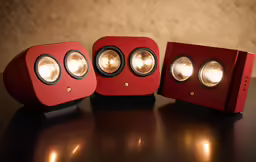 three speakers on the table, one red and one red