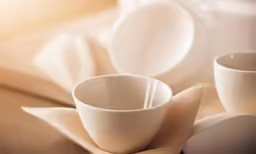 two cups and saucers sit on a table
