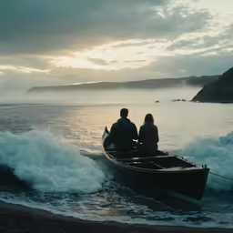 two people sitting in a row boat in the middle of the ocean