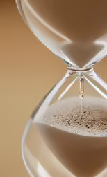 an hourglass with sand in it and a sand pouring through it