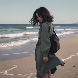 a girl walking on the beach and holding onto a purse