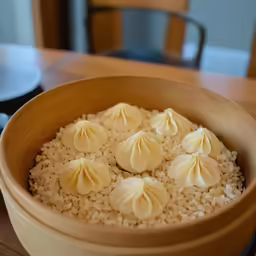 a bowl filled with rice and small dumplings
