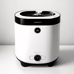 a white and black toaster sitting on top of a table
