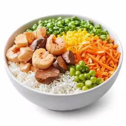 a plate filled with rice, peas, carrots, and other types of vegetables