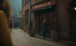 a woman is standing outside of a restaurant on a foggy day