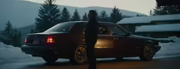 a person standing in front of a car on a road