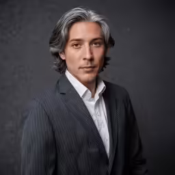 a man is posing for a portrait in a pinstripe suit