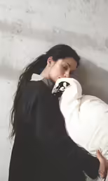 woman in black coat sleeping on white cushion