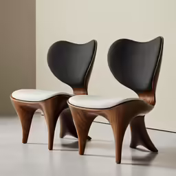 two modern chairs are sitting in a room