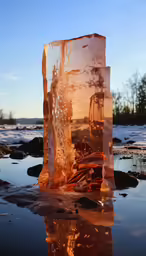 an ice block floats in the water at sunset