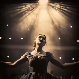 a woman in a ball gown is dancing on stage
