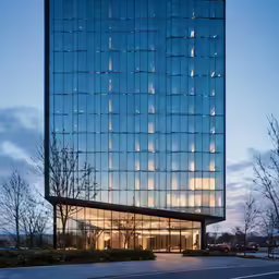 glass building with windows that are reflecting the evening sky