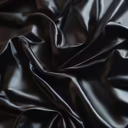 closeup of black satin fabric that is unraveled