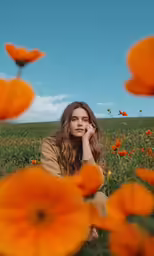 a woman in a field of flowers with her hand on her face