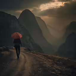 the man walks down the road with an umbrella