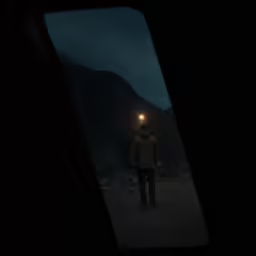 a person walking in the dark with one light on