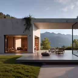 the outdoor patio is surrounded by grass, and there are mountains in the distance