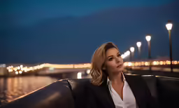 woman in business suit on the dock in front of light posts