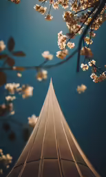 there is a tall building and tree that has flowers on it
