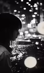 a woman holding an umbrella at night in the rain