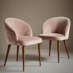 two light pink velvet chairs with dark wood legs